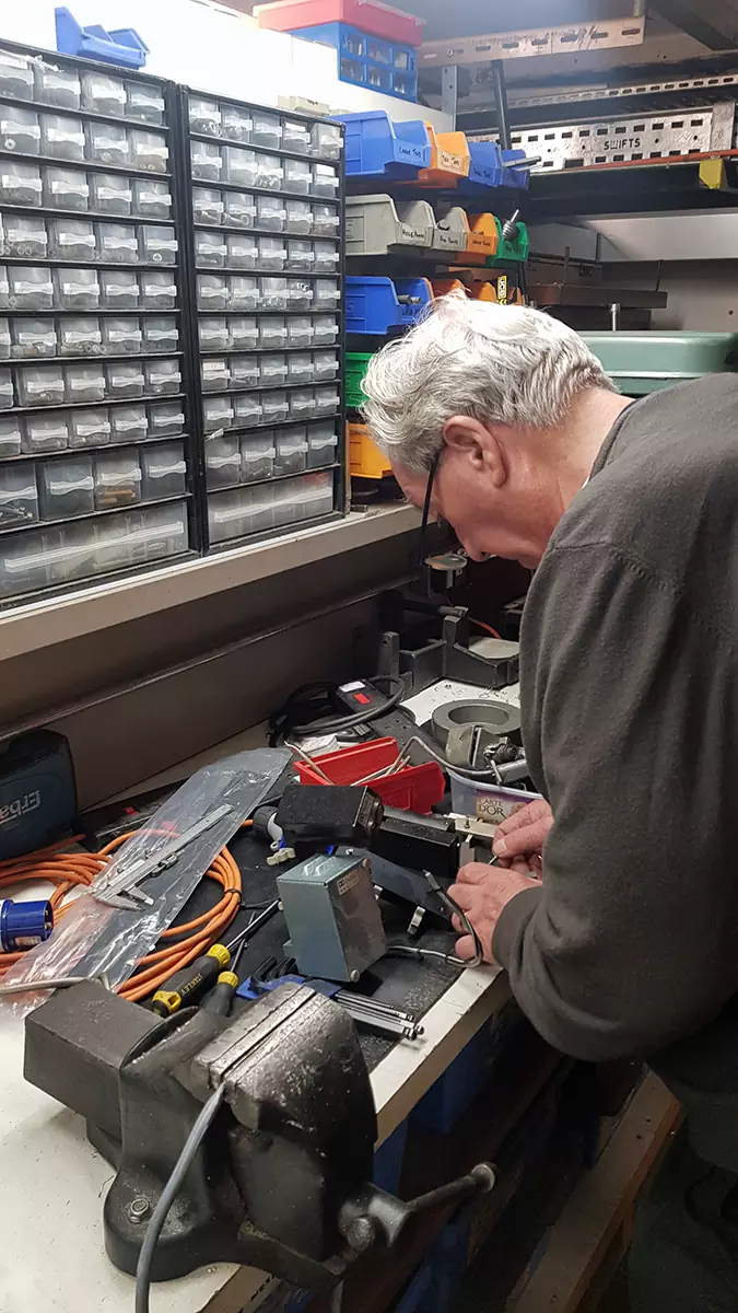 Mike assembling the digital reader on the bench